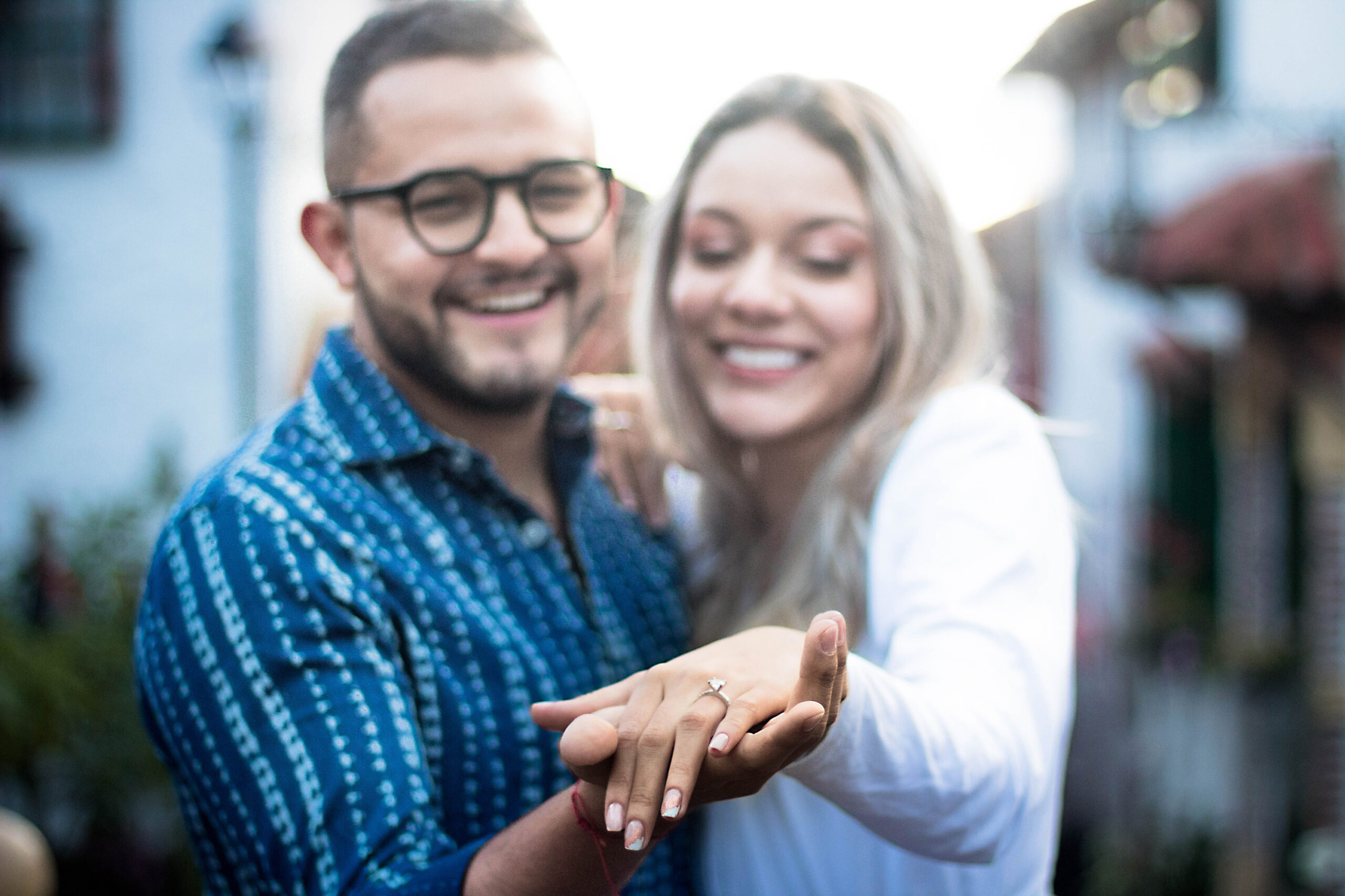 Happy Caucasian couple just married showing the ring