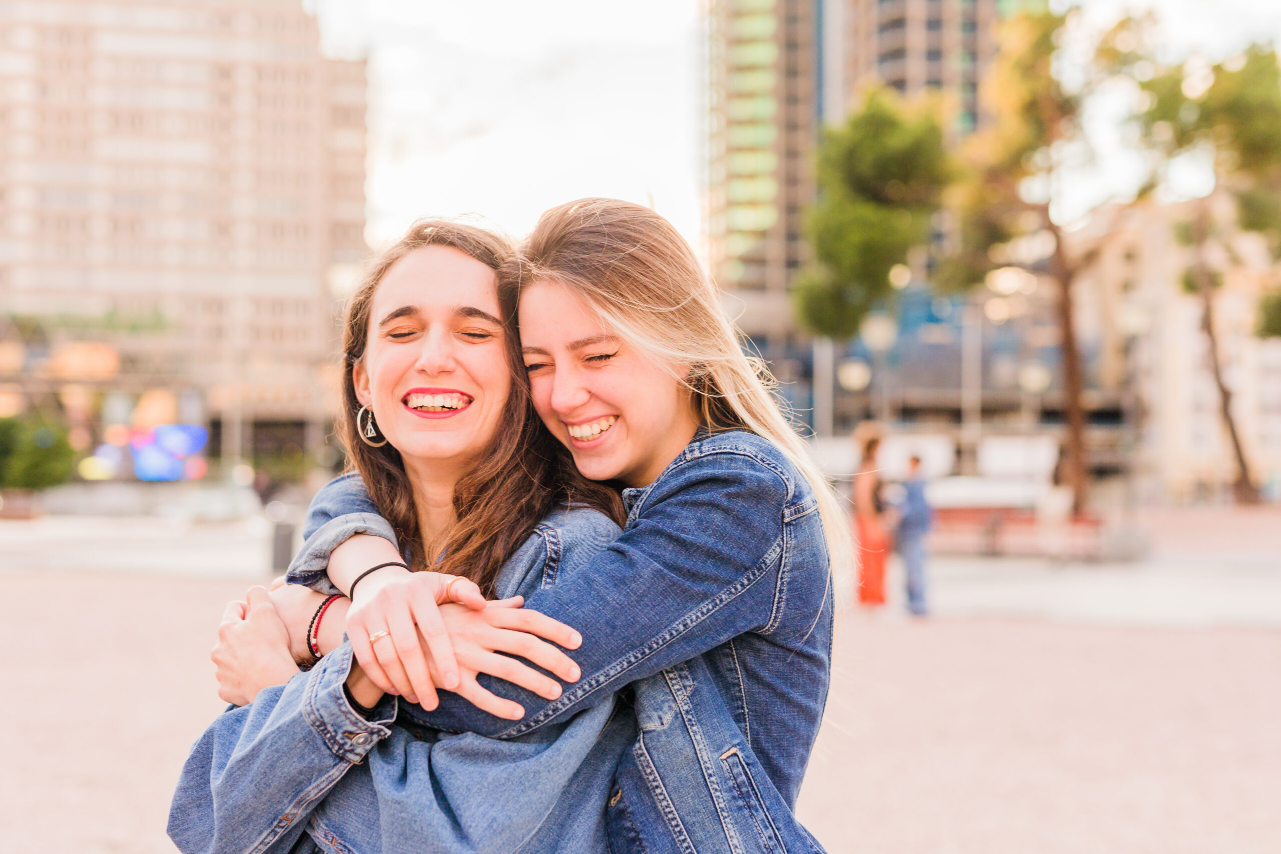 Lesbian young multiethnic couple hug on a sunlight sunrise. Together happiness girlfriends
